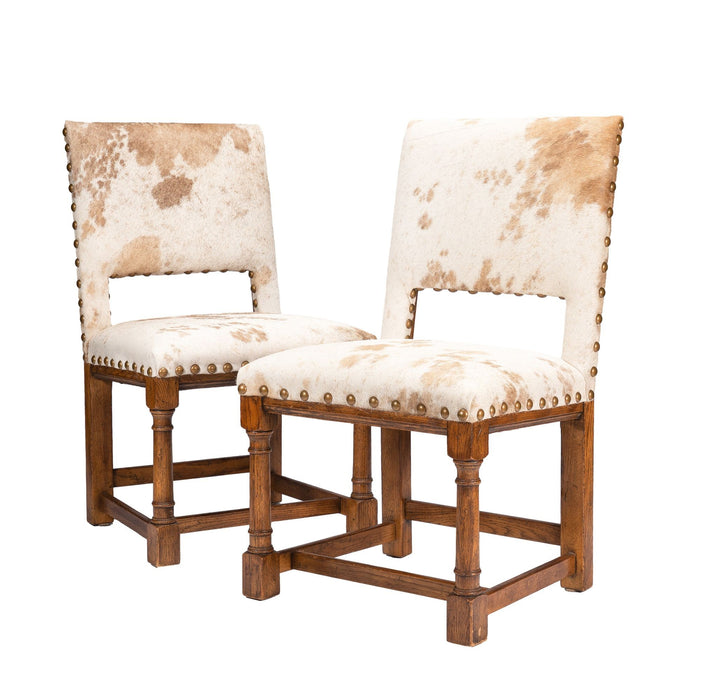 Pair of Jacobean style hair on hide oak side chairs (c. 1920-35)