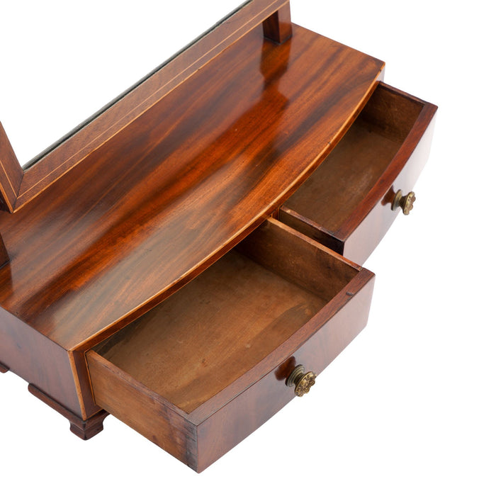 Rectangular mahogany dressing mirror on a bow front stand with drawer (c. 1790)