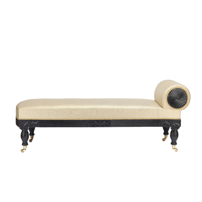 American Eastlake upholstered chaise in ebonized walnut with brass casters (1888)