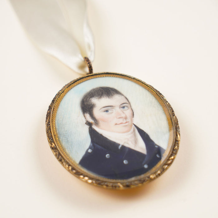 New England gentleman's portrait on a bone pendant in a gilt bezel (c. 1810)