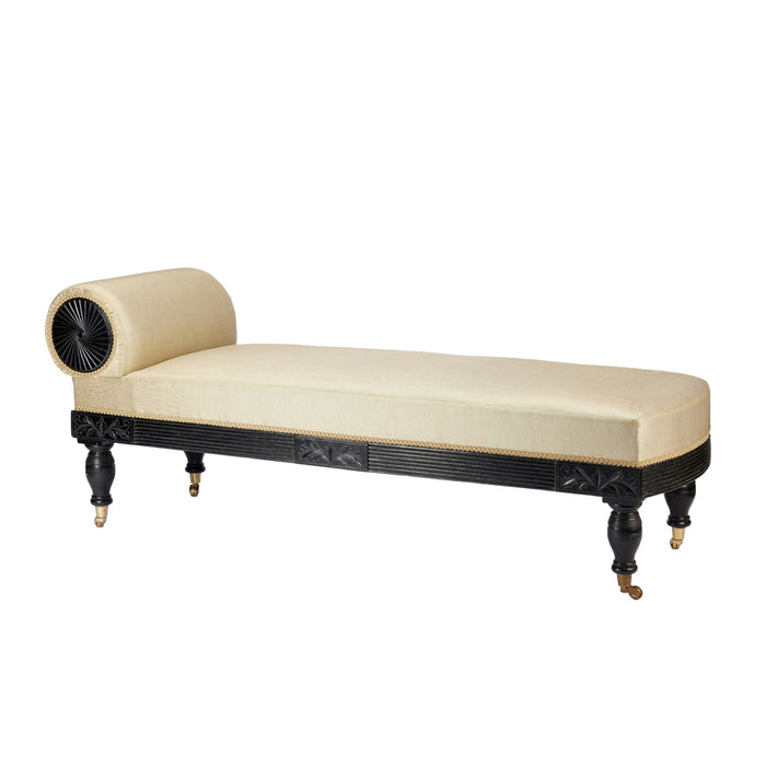 American Eastlake upholstered chaise in ebonized walnut with brass casters (1888)