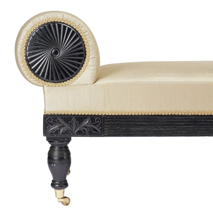 American Eastlake upholstered chaise in ebonized walnut with brass casters (1888)