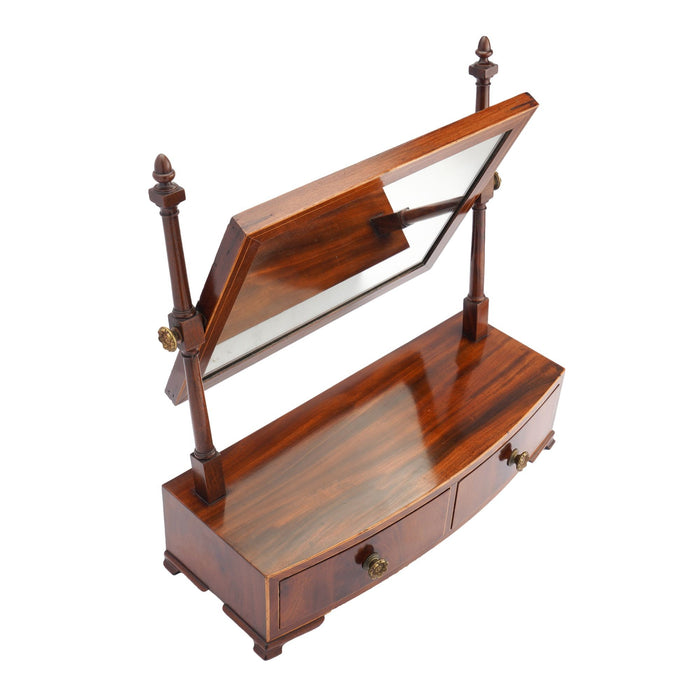 Rectangular mahogany dressing mirror on a bow front stand with drawer (c. 1790)