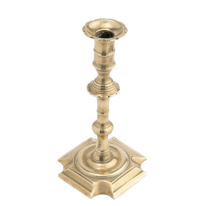English Queen Anne cast brass cove cut corner base candlestick (c. 1725-50)