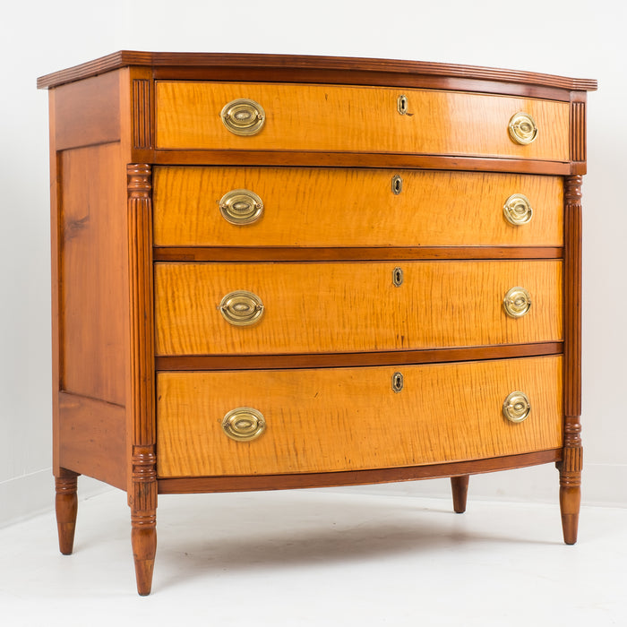 American Sheraton cherry and curly maple four drawer bow front chest (c. 1815)