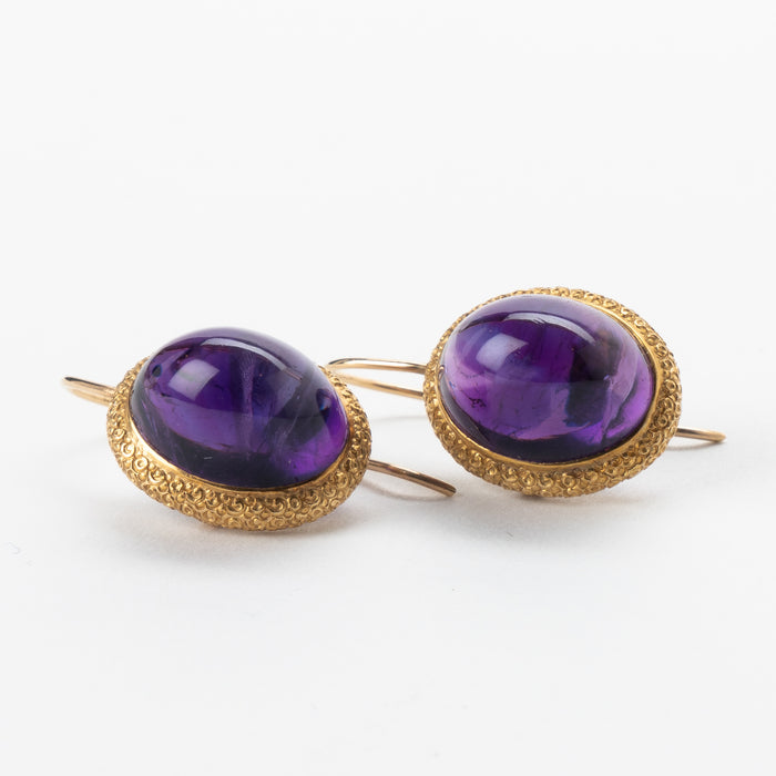 Pair of English cabochon amethyst earrings set in 14k gold engraved bezel (c. 1880)