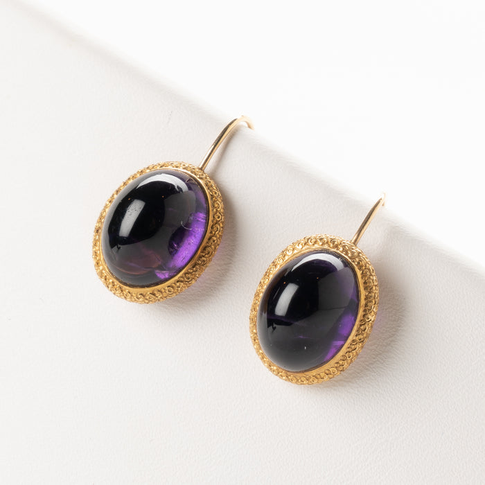 Pair of English cabochon amethyst earrings set in 14k gold engraved bezel (c. 1880)