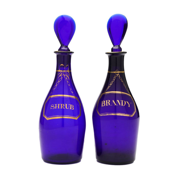 Pair of pyriform blown cobalt blue glass spirit decanters labeled Brandy & Shrub (1790-1810)