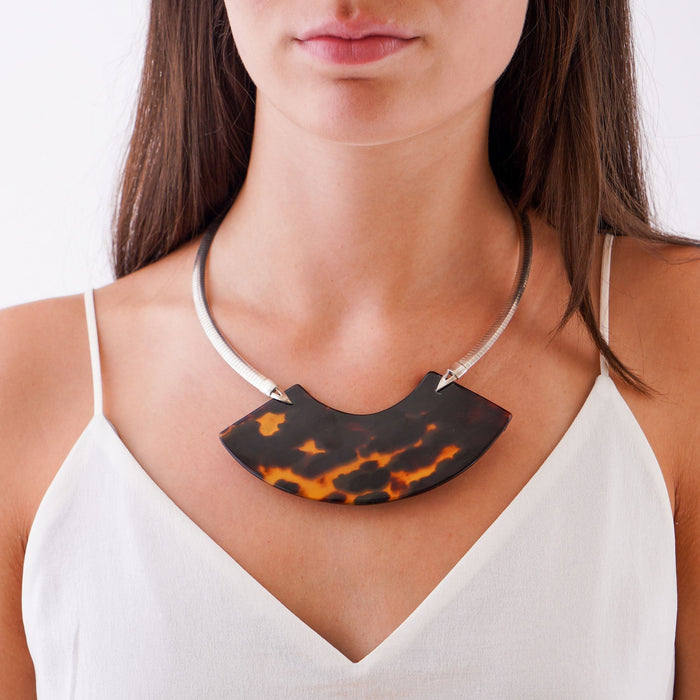 Tortoise shell crescent necklace on a sterling omega