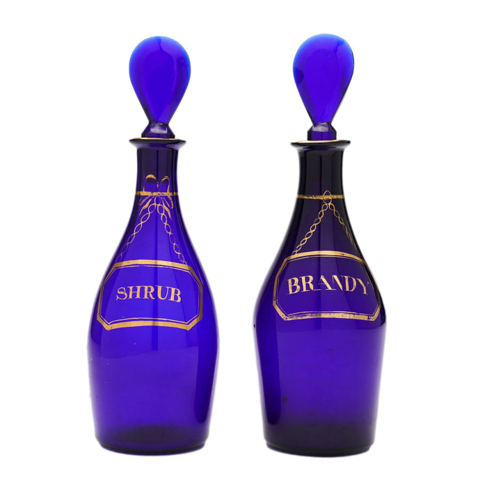 Pair of pyriform blown cobalt blue glass spirit decanters labeled Brandy & Shrub (1790-1810)