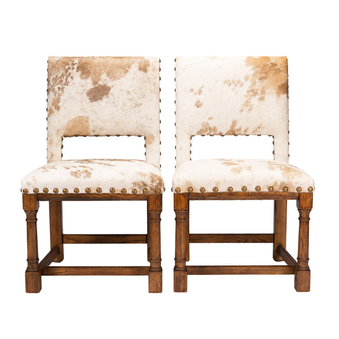 Pair of Jacobean style hair on hide oak side chairs (c. 1920-35)