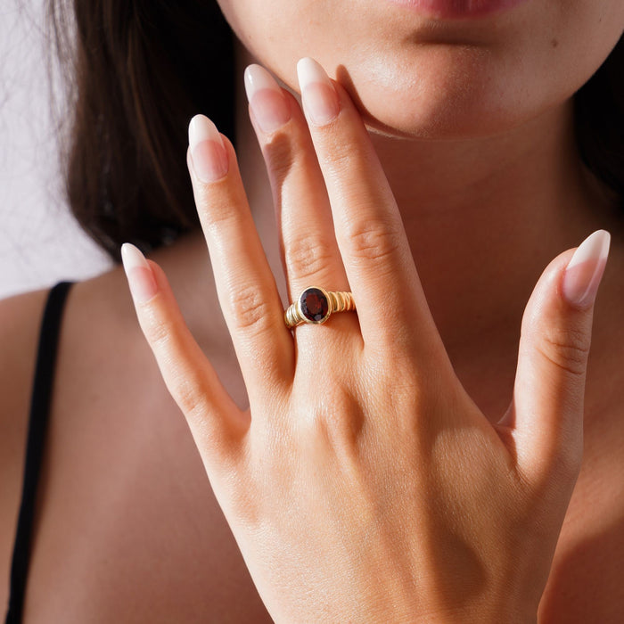 18k gold ring set with a facet cut oval rubellite tourmaline