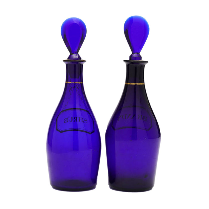 Pair of pyriform blown cobalt blue glass spirit decanters labeled Brandy & Shrub (1790-1810)