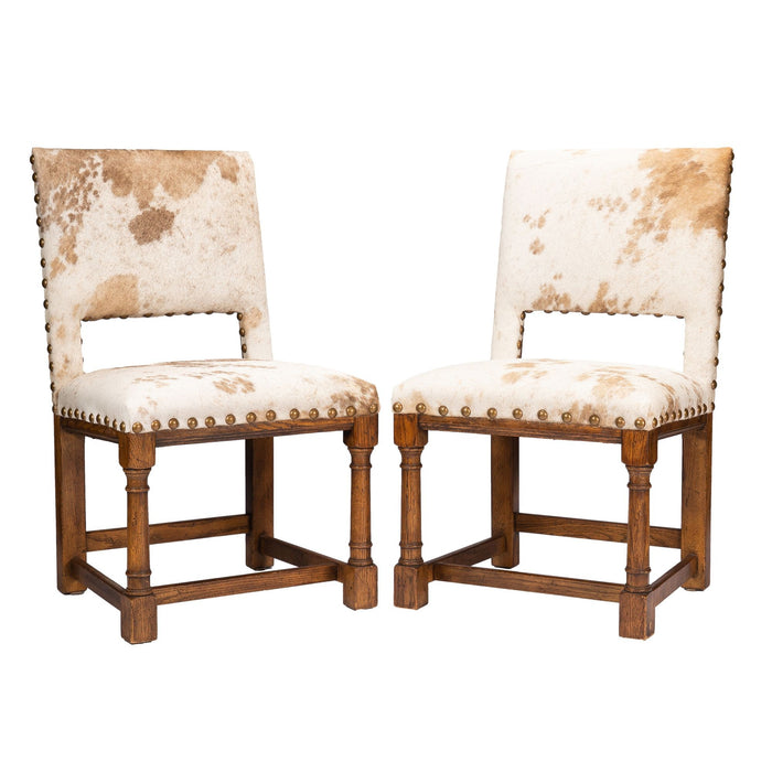 Pair of Jacobean style hair on hide oak side chairs (c. 1920-35)