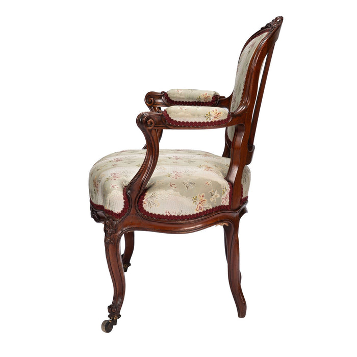 French Louis Philippe Period upholstered walnut arm chair with paired footstool (1850's)