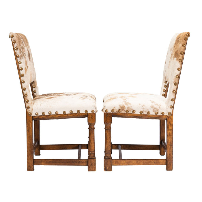 Pair of Jacobean style hair on hide oak side chairs (c. 1920-35)