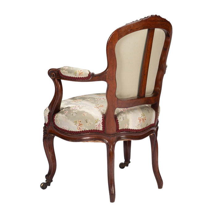 French Louis Philippe Period upholstered walnut arm chair with paired footstool (1850's)