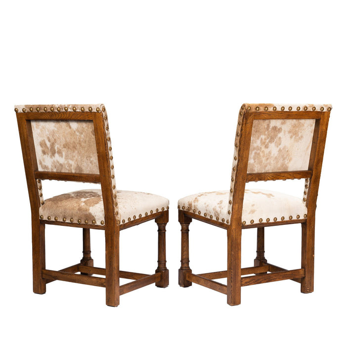 Pair of Jacobean style hair on hide oak side chairs (c. 1920-35)