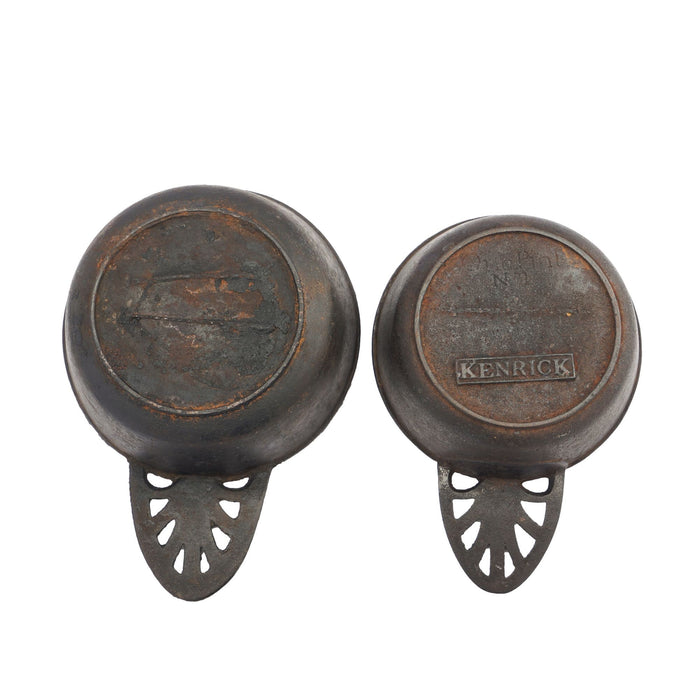 Two graduated cast iron porringers by Kenrick Iron Mongers (1790-1830)