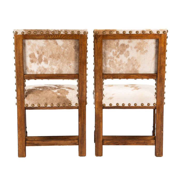 Pair of Jacobean style hair on hide oak side chairs (c. 1920-35)