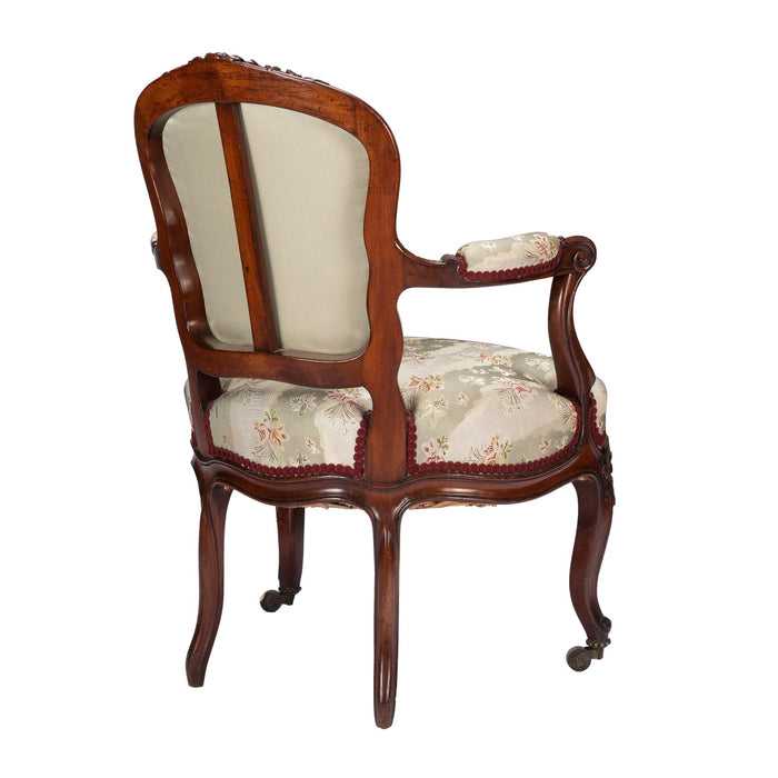 French Louis Philippe Period upholstered walnut arm chair with paired footstool (1850's)