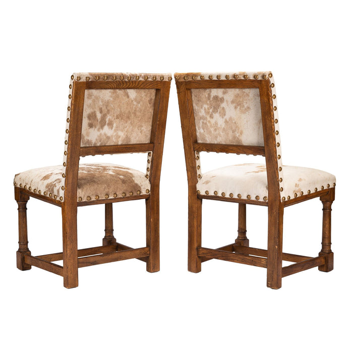 Pair of Jacobean style hair on hide oak side chairs (1920-35)