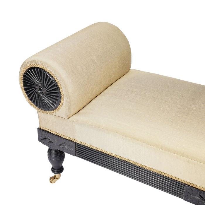 American Eastlake upholstered chaise in ebonized walnut with brass casters (1888)