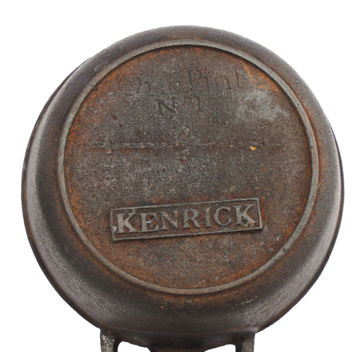 Two graduated cast iron porringers by Kenrick Iron Mongers (1790-1830)