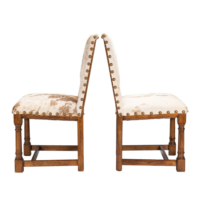 Pair of Jacobean style hair on hide oak side chairs (c. 1920-35)