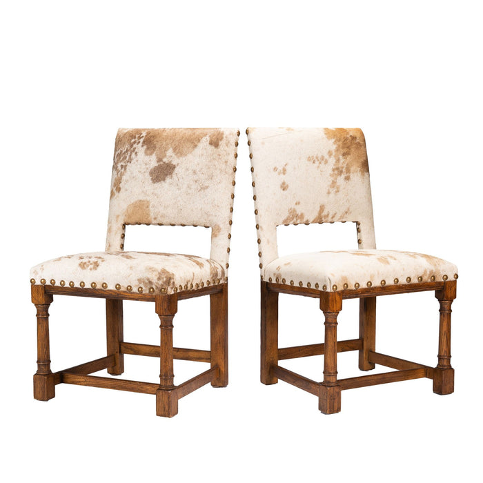 Pair of Jacobean style hair on hide oak side chairs (c. 1920-35)