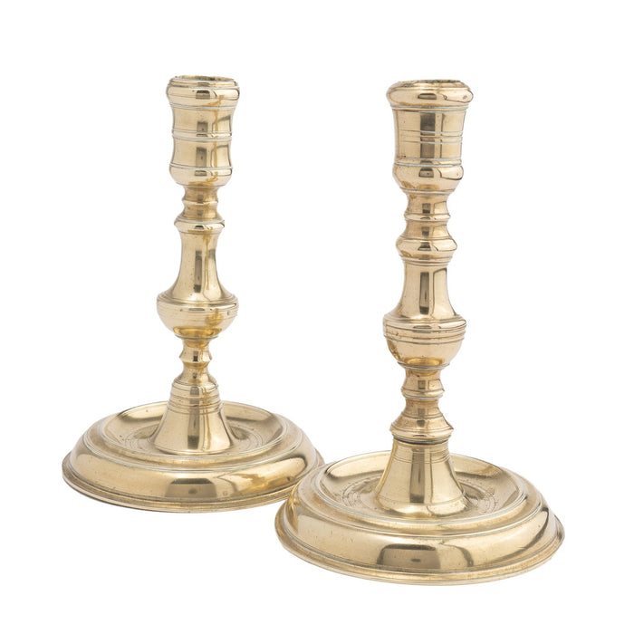 Assembled pair of French cast brass chamber candlesticks (1710-20)