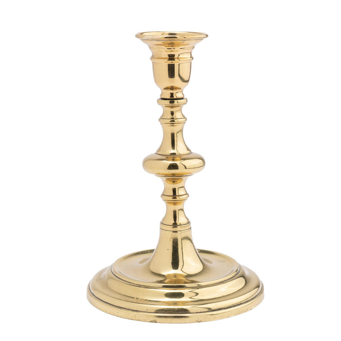 Continental cast brass circular base candlestick (c. 1720-40)
