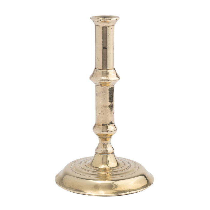 English canon barrel brass candlestick on domed base, 1720-40