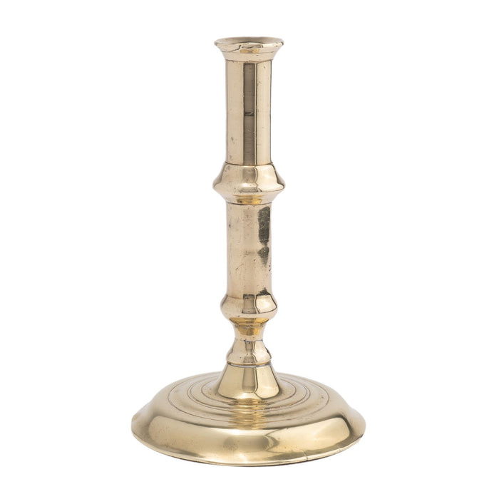 English canon barrel brass candlestick on domed base (c. 1720-40)