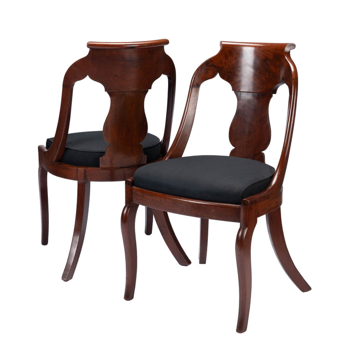 Pair of American mahogany upholstered slip seat gondola chairs (1830-35)