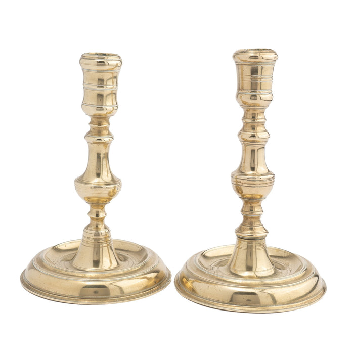 Assembled pair of French cast brass chamber candlesticks (c. 1710-20)