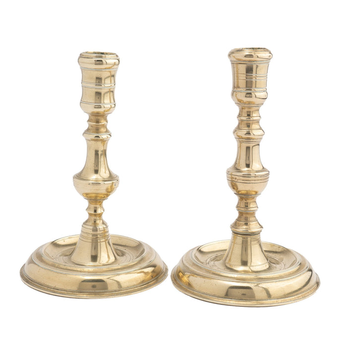 Assembled pair of French cast brass chamber candlesticks (1710-20)