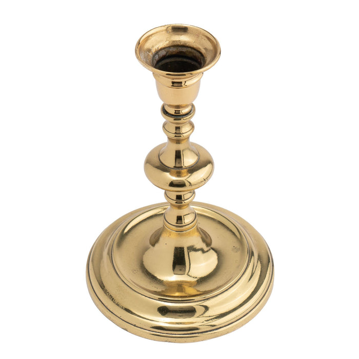 Continental cast brass circular base candlestick (c. 1720-40)