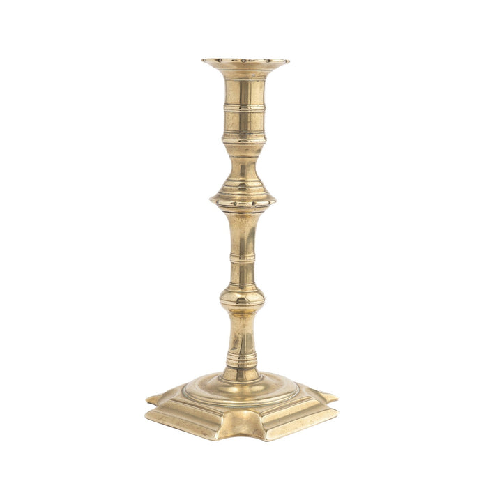 English Queen Anne cast brass cove cut corner base candlestick (1725-50)