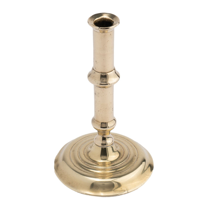 English canon barrel brass candlestick on domed base (c. 1720-40)