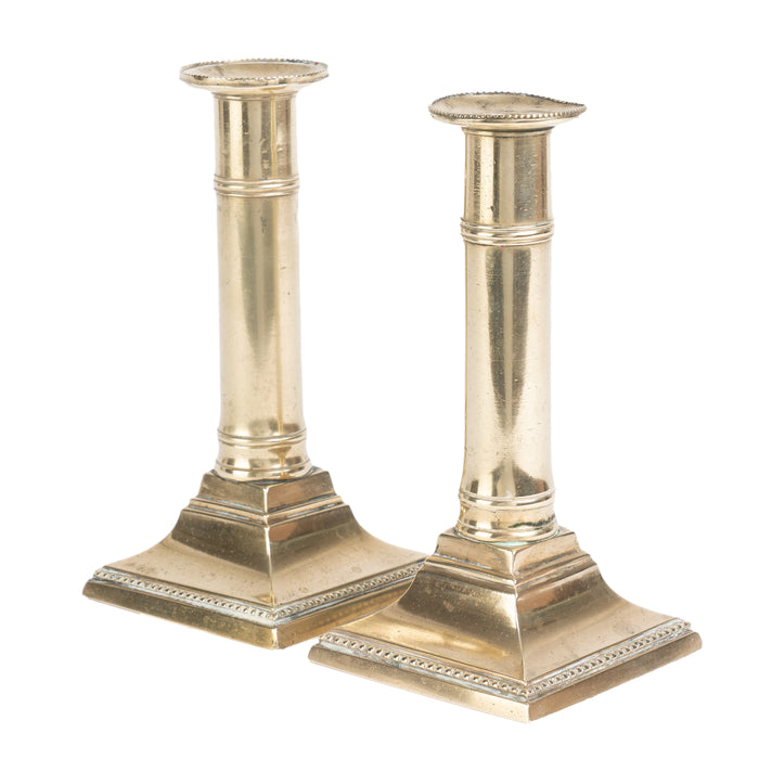 Pair of English cast brass columnar candle sticks on a square base (1810)