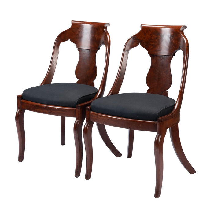 Pair of American mahogany upholstered slip seat gondola chairs (1830-35)