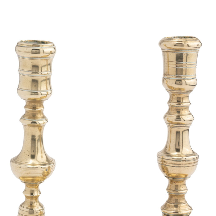Assembled pair of French cast brass chamber candlesticks (c. 1710-20)