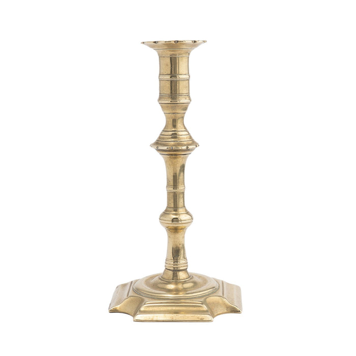 English Queen Anne cast brass cove cut corner base candlestick (c. 1725-50)