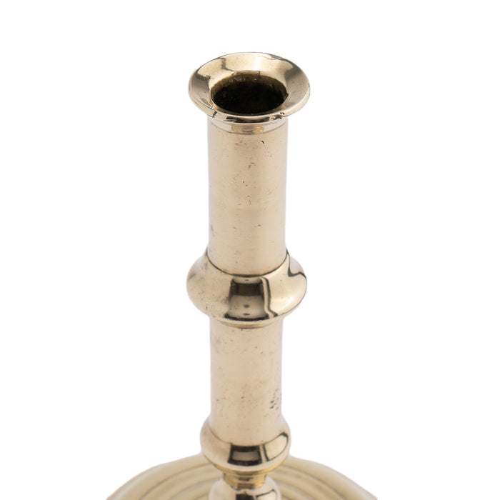 English canon barrel brass candlestick on domed base, 1720-40