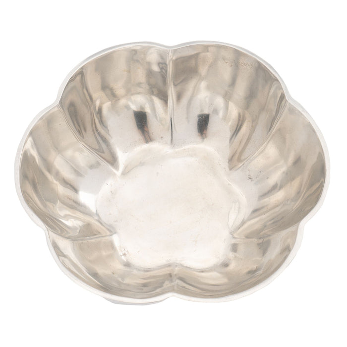 Contemporary cast metal six lobe bowl with flat bottom
