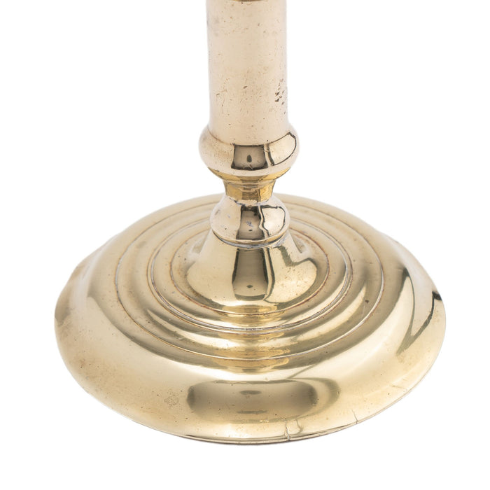 English canon barrel brass candlestick on domed base (c. 1720-40)