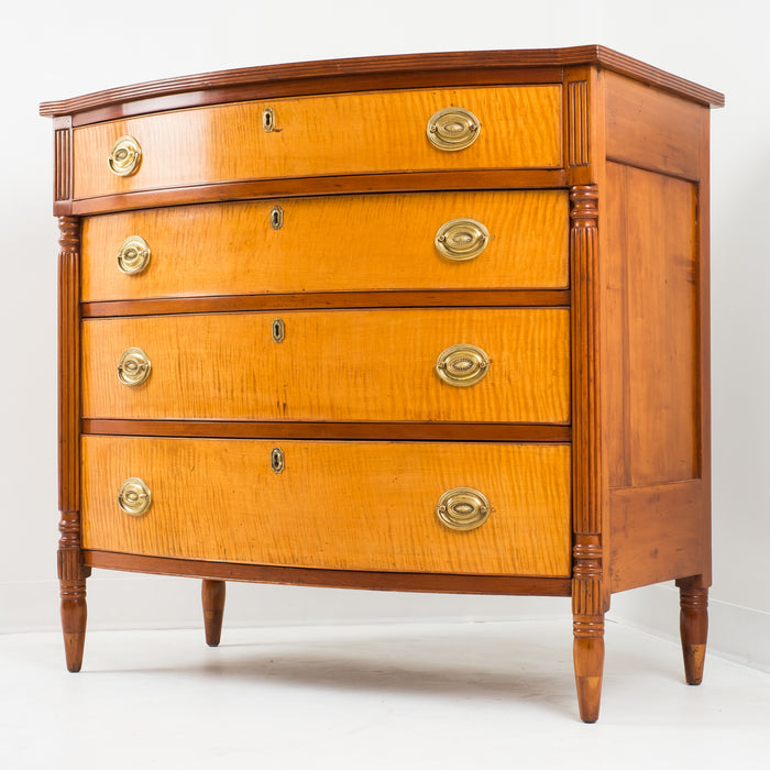 American Sheraton cherry and curly maple four drawer bow front chest (c. 1815)