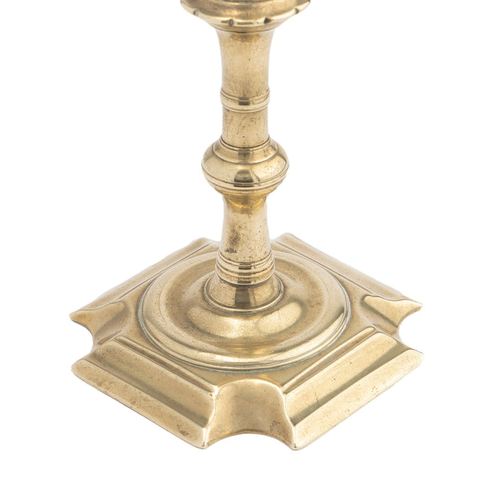 English Queen Anne cast brass cove cut corner base candlestick (1725-50)