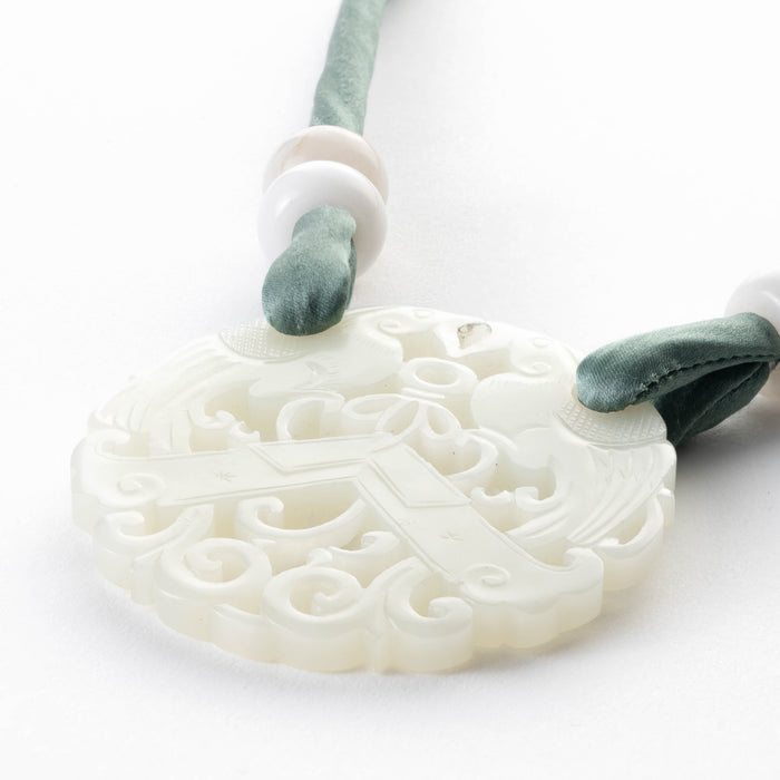 White nephrite jade carved and pierced circular pendant (1800's)